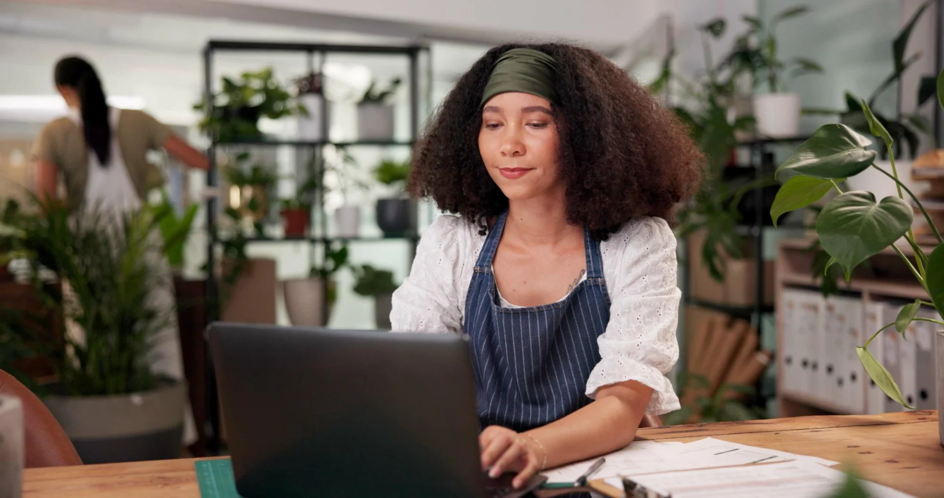 A small business owner working at a laptop, weighing up going limited