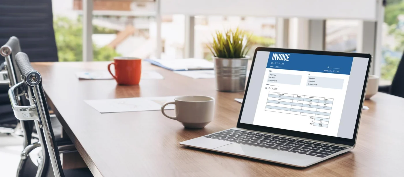 A growing small-business owner reviewing sales figures on a laptop