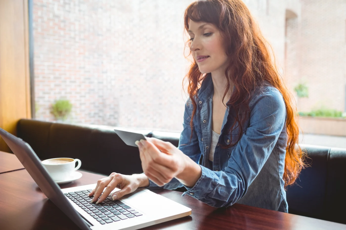 A small-business owner reviewing finances on a tablet in a studio