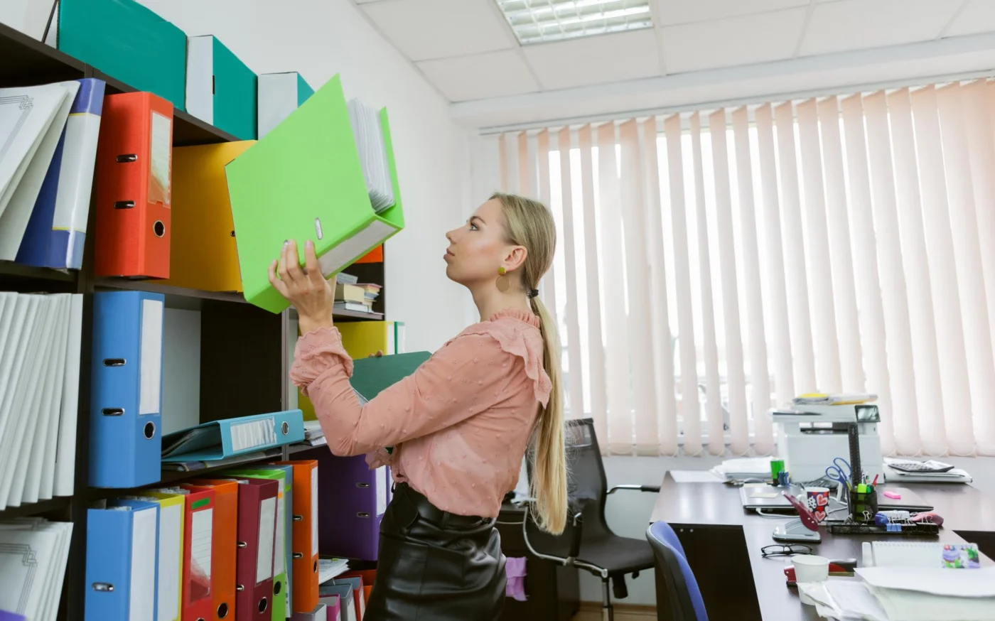 A director organising company paperwork at a tidy desk