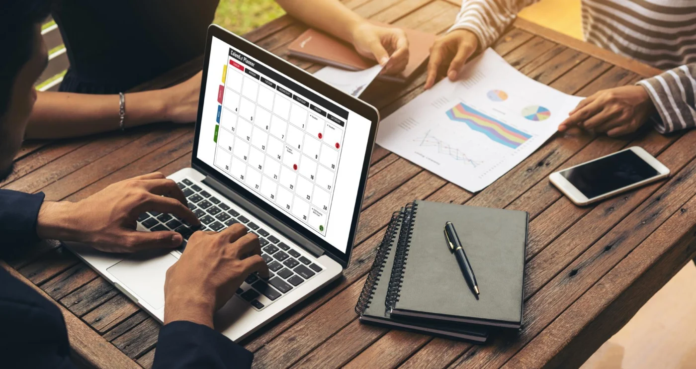 A wall calendar and company documents on a desk, suggesting an older incorporation date