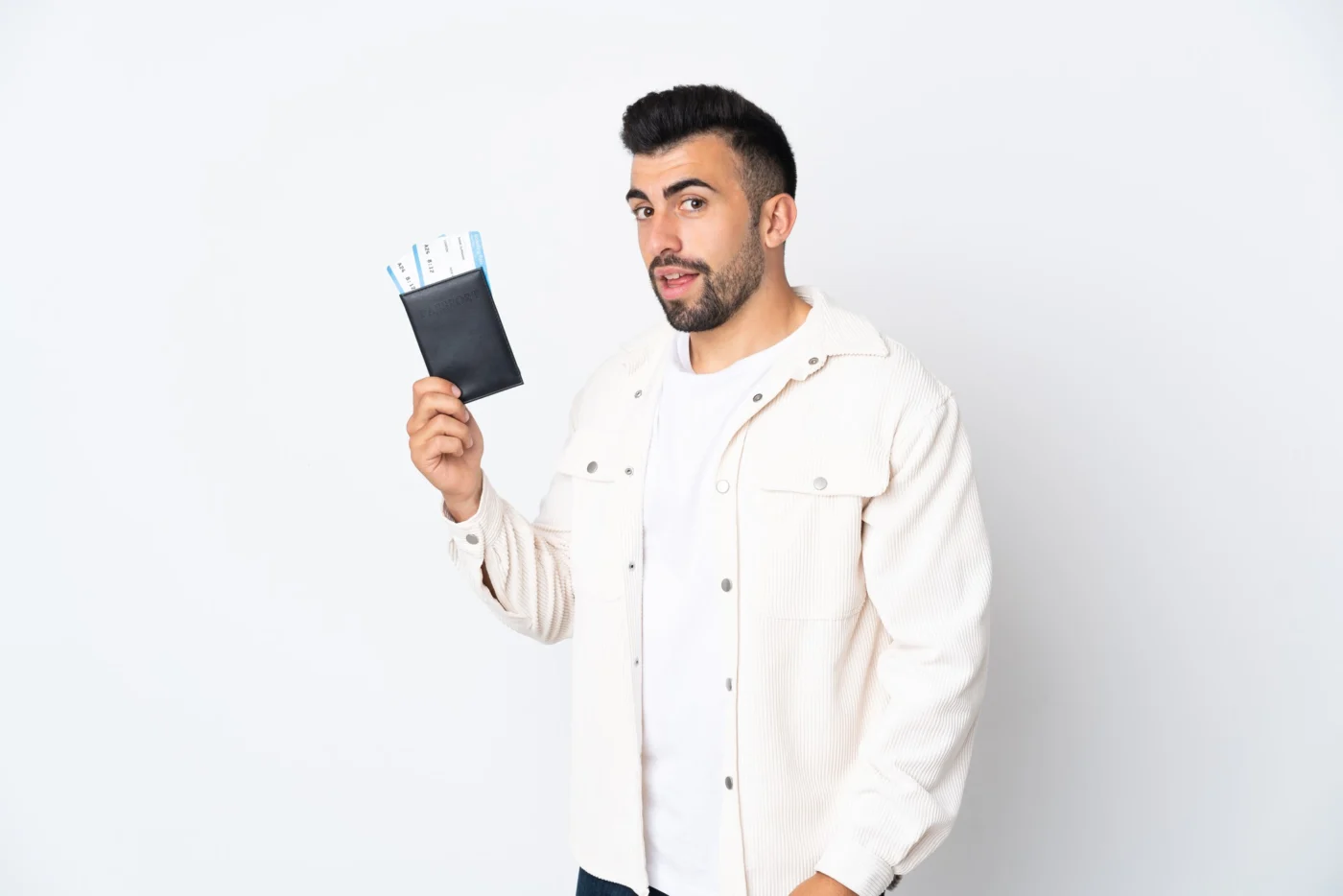 A director holding a passport beside a laptop while verifying their identity online