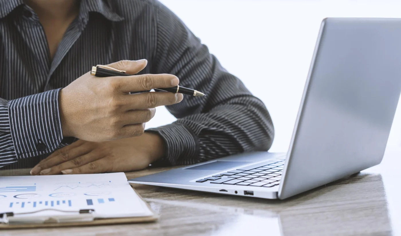 A director discussing pension options with an adviser across a desk