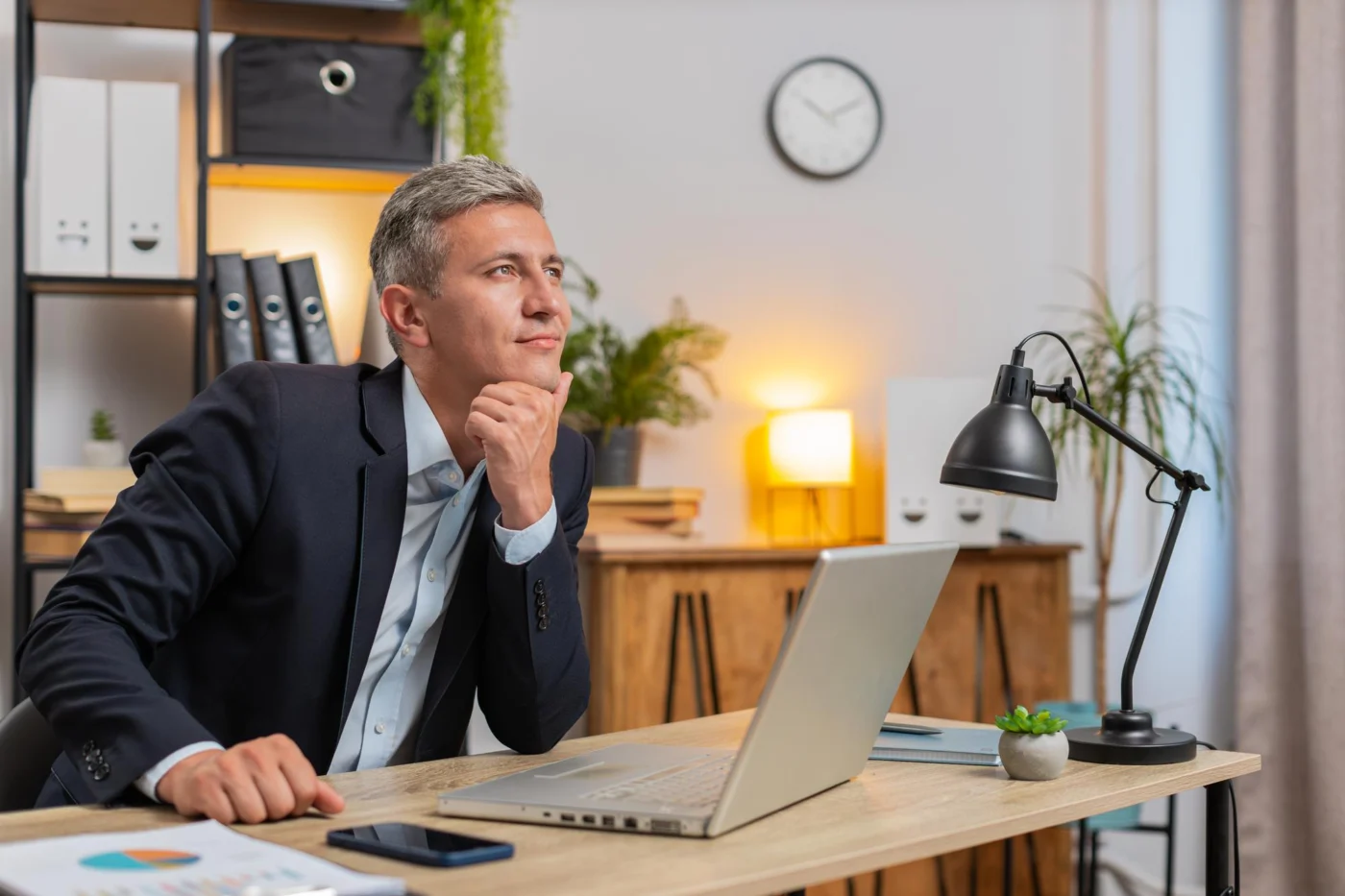 A business owner reviewing notes before deciding to pause or close