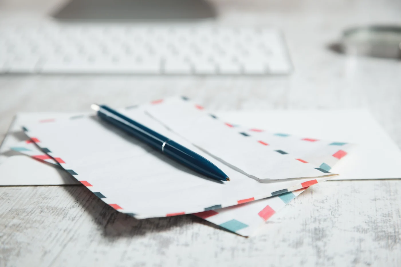 Official business letters and post stacked on a desk