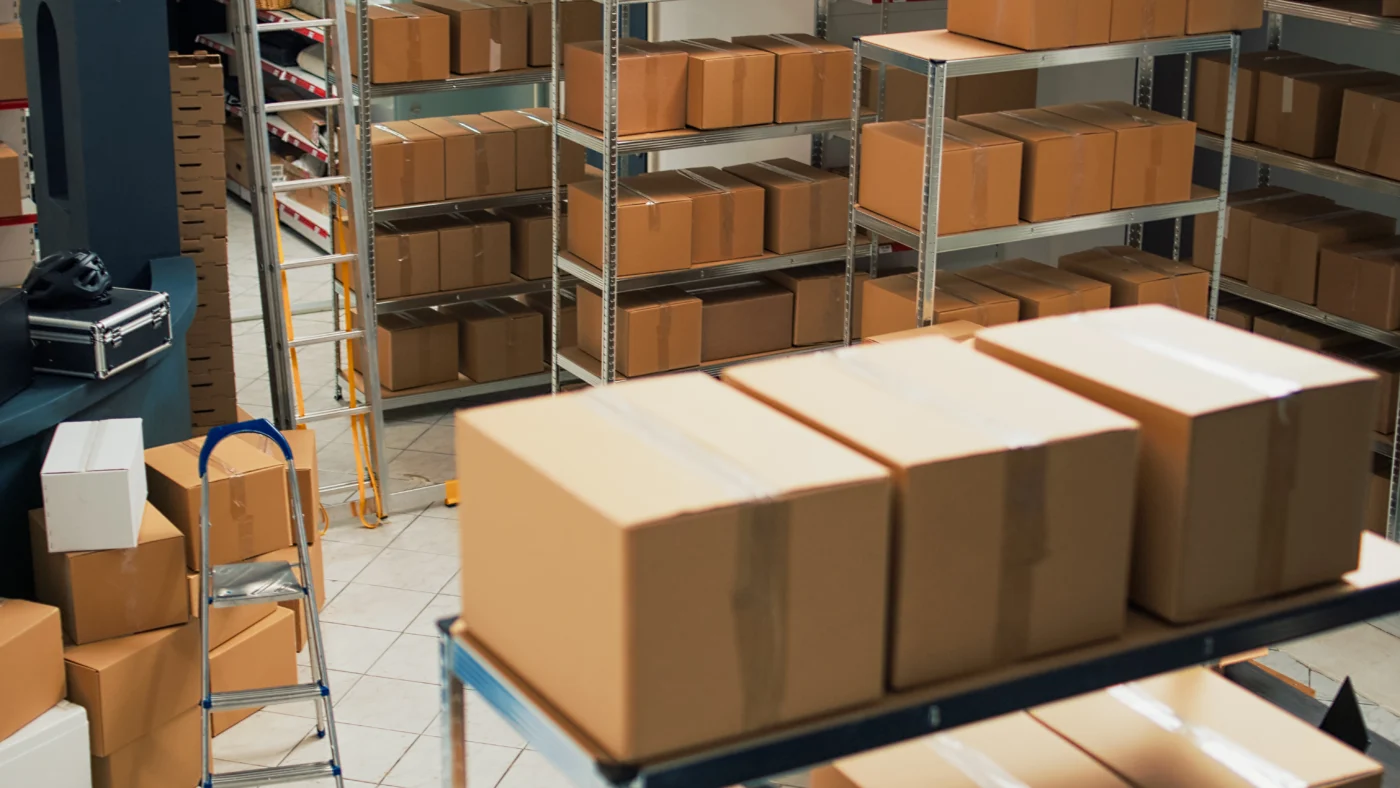 Boxes of stock and supplier invoices in a small warehouse