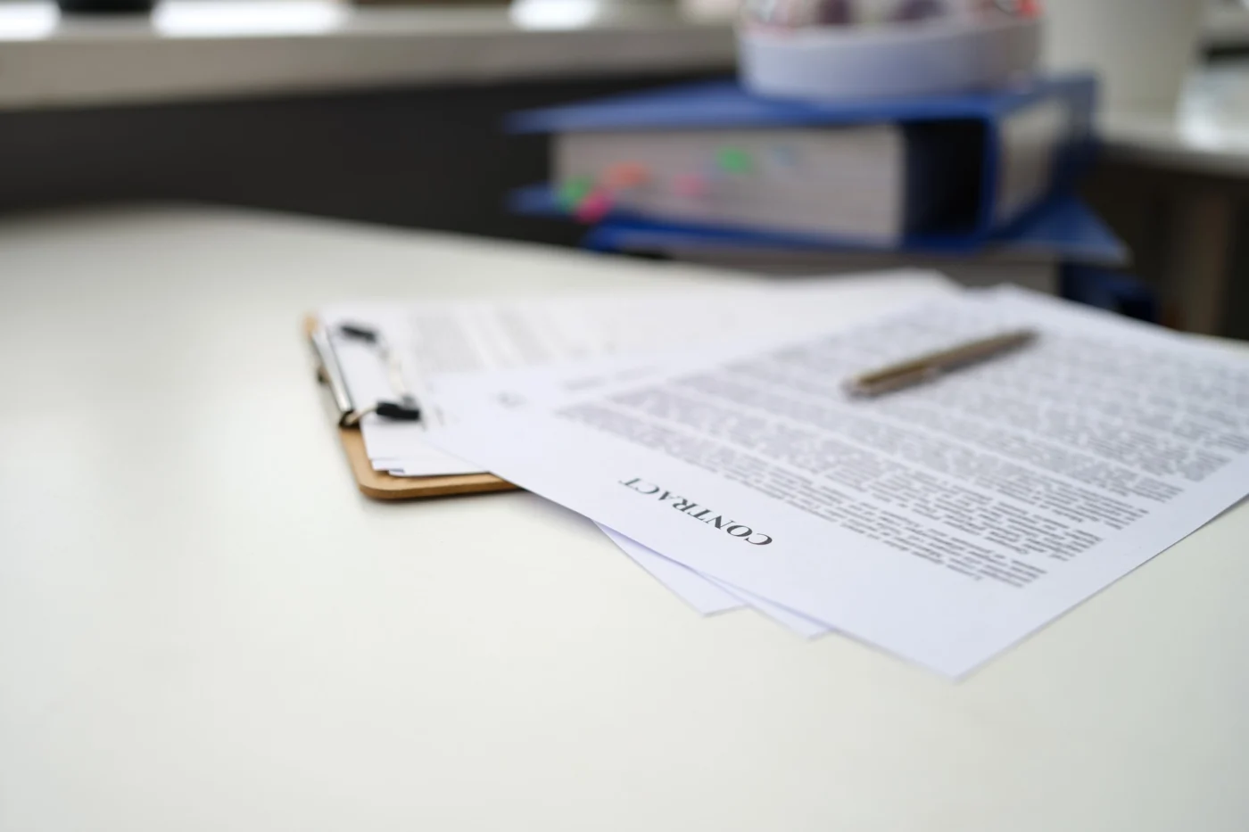 A share certificate and a register of members on a desk
