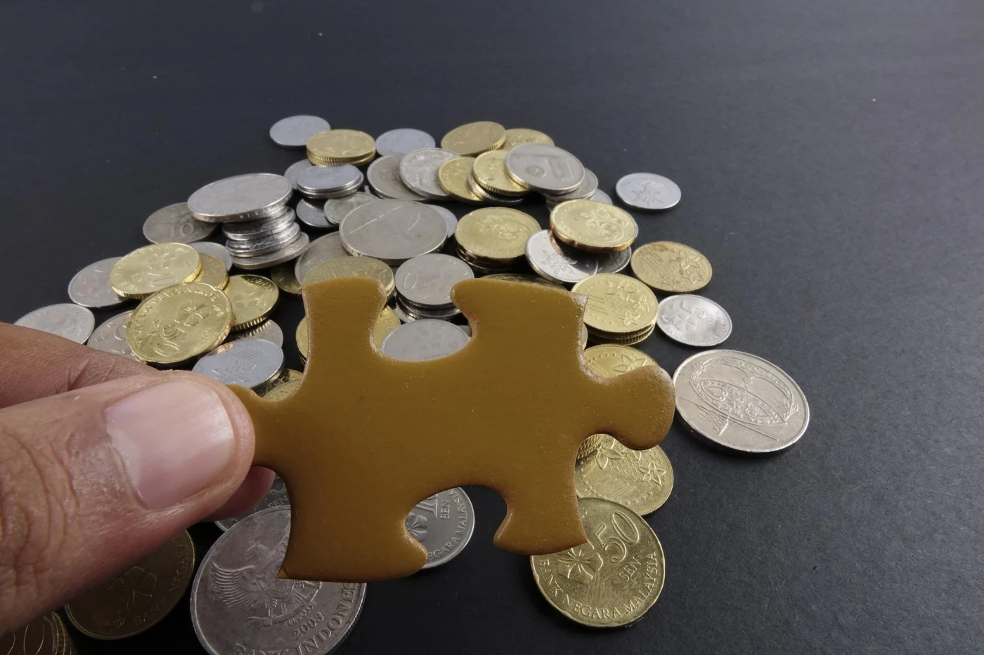 Hand holding coins, representing capital and investment